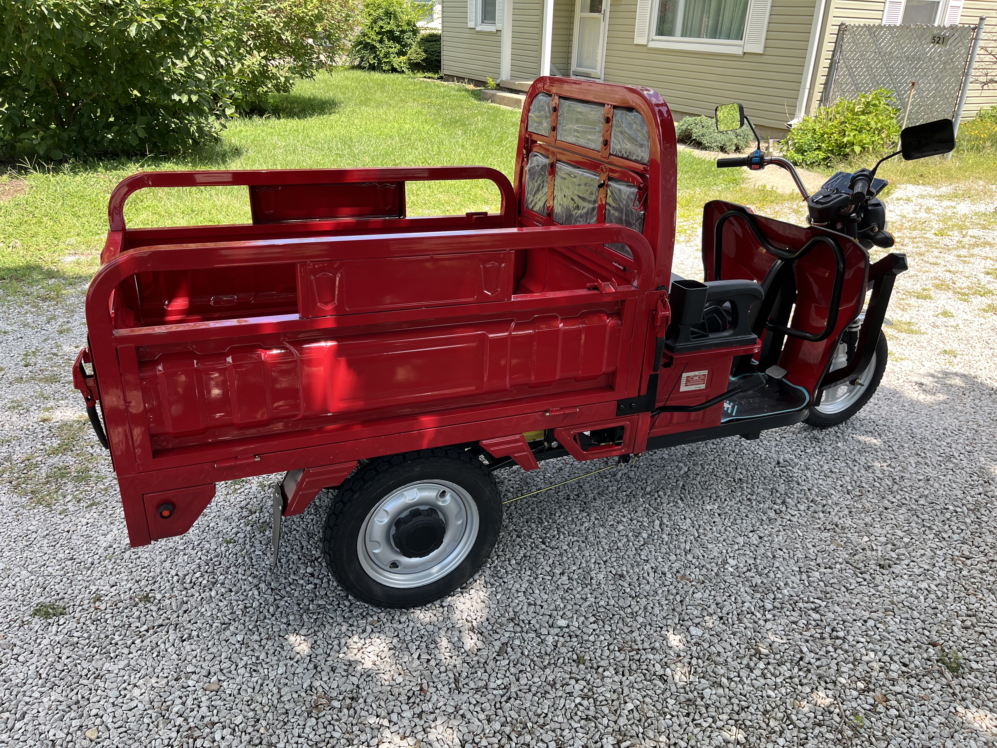 Red electric tricycle before its candy cart conversion